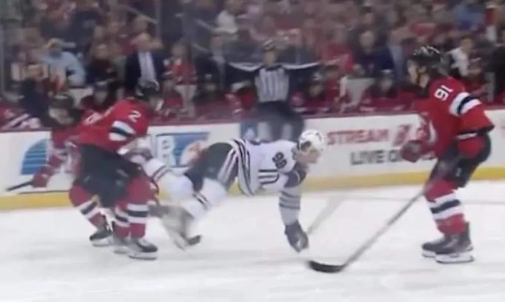 Chicago Blackhawks forward Connor Bedard being hit by the New Jersey Devils defenseman Brendan Smith