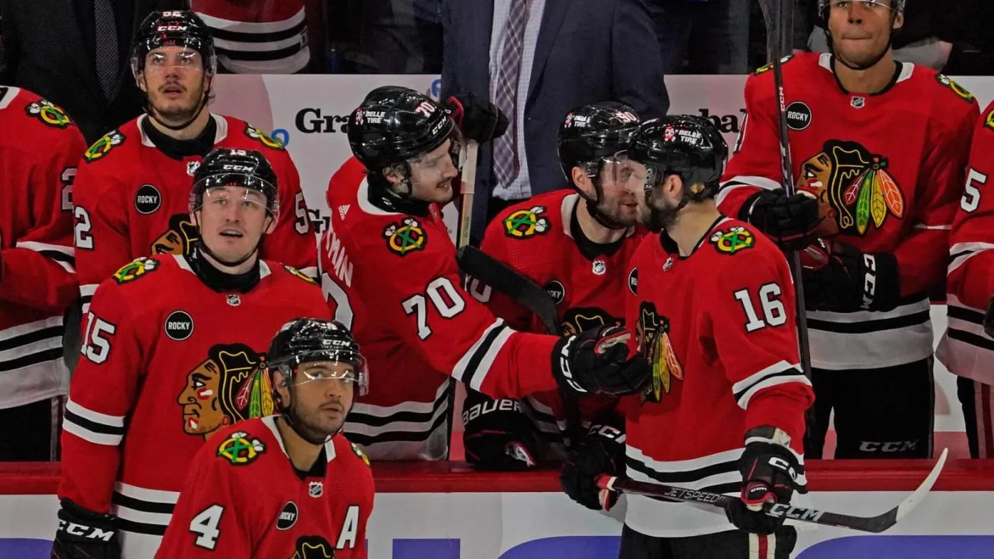 Chicago Blackhawks players standing at their bench