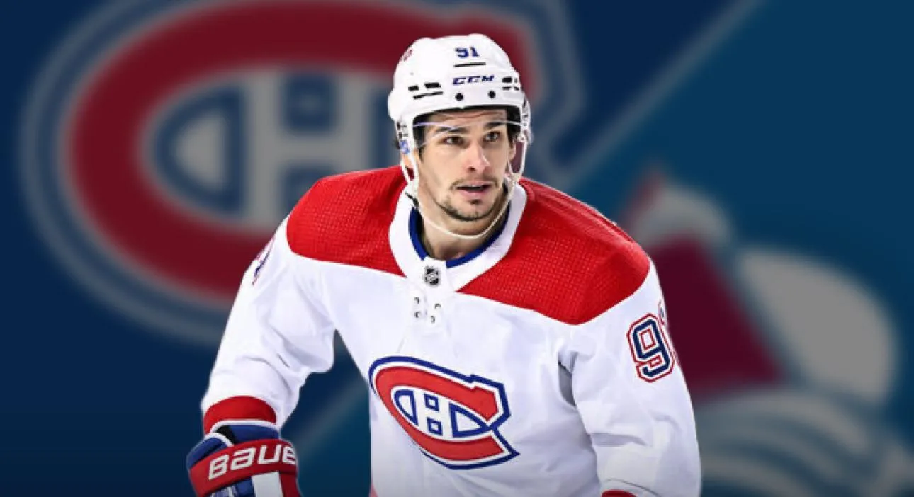 Montreal Canadiens forward Sean Monahan in front of the Colorado Avalanche logo