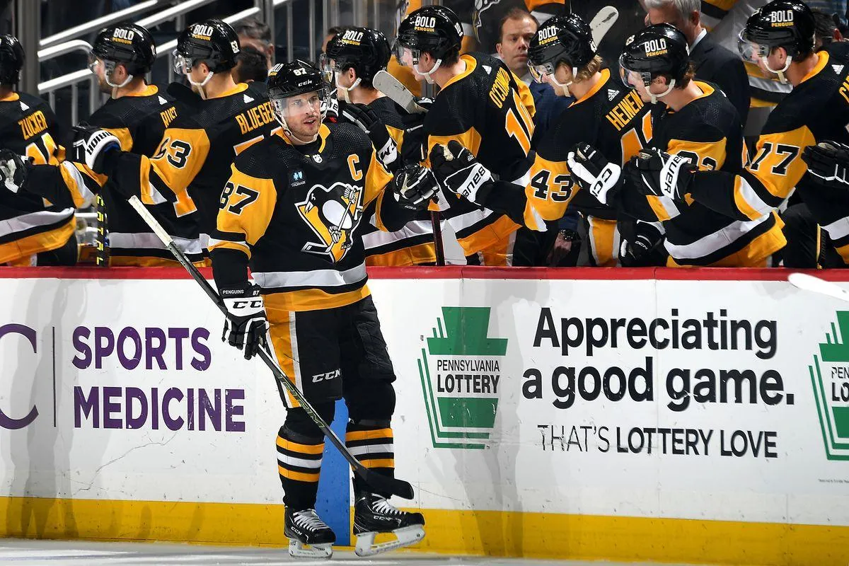 Penguins Captain Sidney Crosby gets high-fives from the bench after scoring
