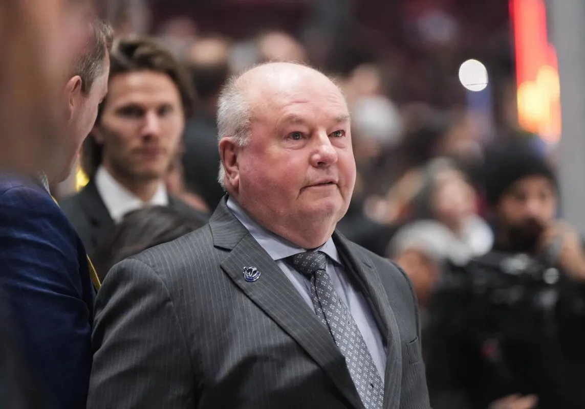 Former Head Coach Bruce Boudreau on the bench during a game.