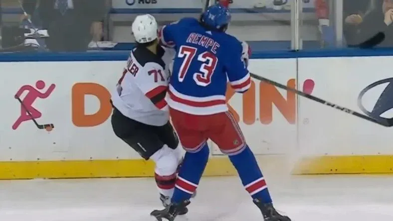 New York Rangers' Matt Rempe landing a dangerous hit on New Jersey Devils' Jonas Siegenthaler in a game.