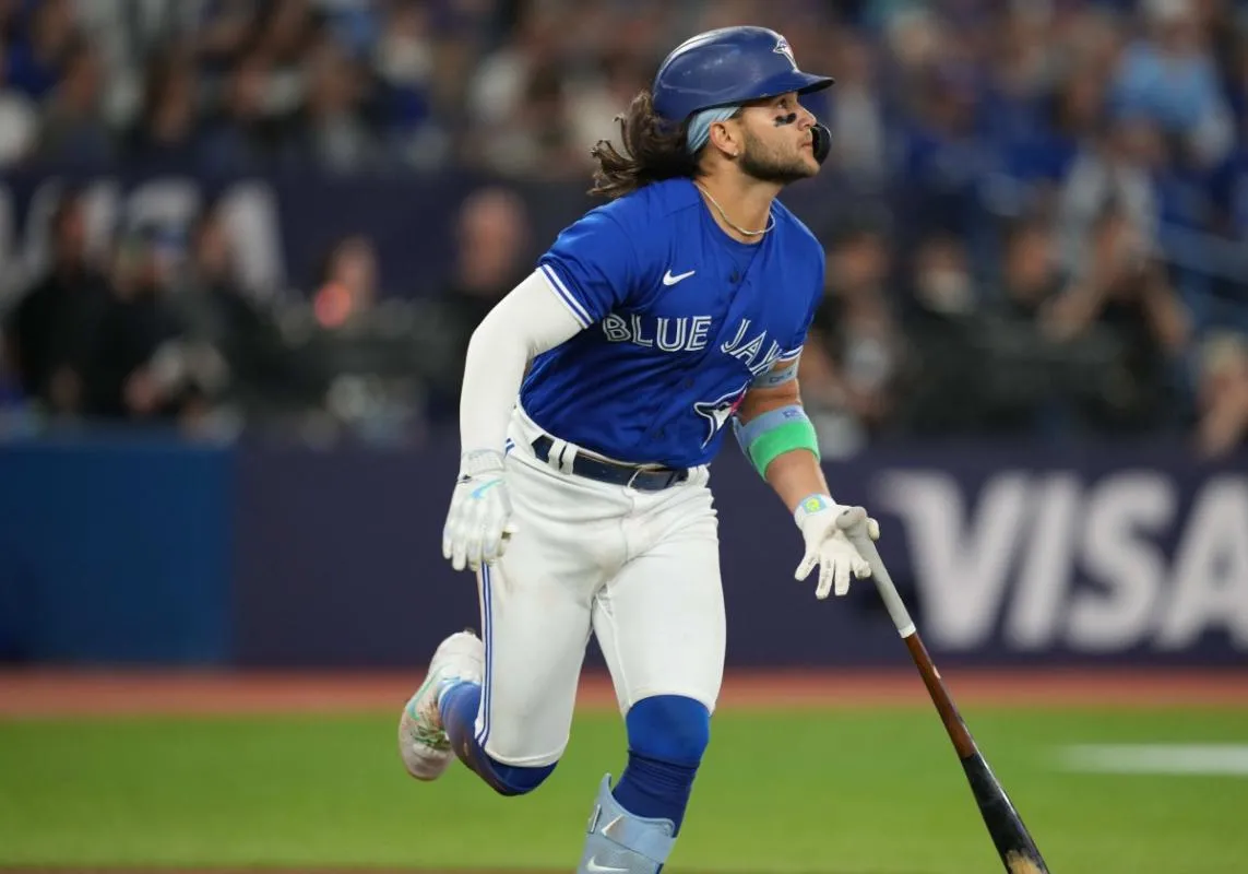 Bichette watches his hit as he heads for first base.