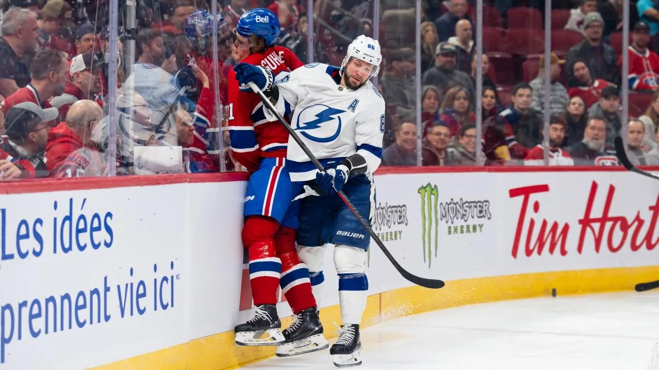 Nikita Kucherov landing a hit on Kaiden Guhle in the game between the Tampa Bay Lightning and the Montreal Canadiens.