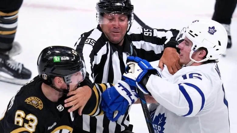 Referee breaking up fight between the Toronto Maple Leafs and Boston Bruins