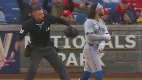 Bo Bichette walking to the dugout after slamming helmet and being ejected.
