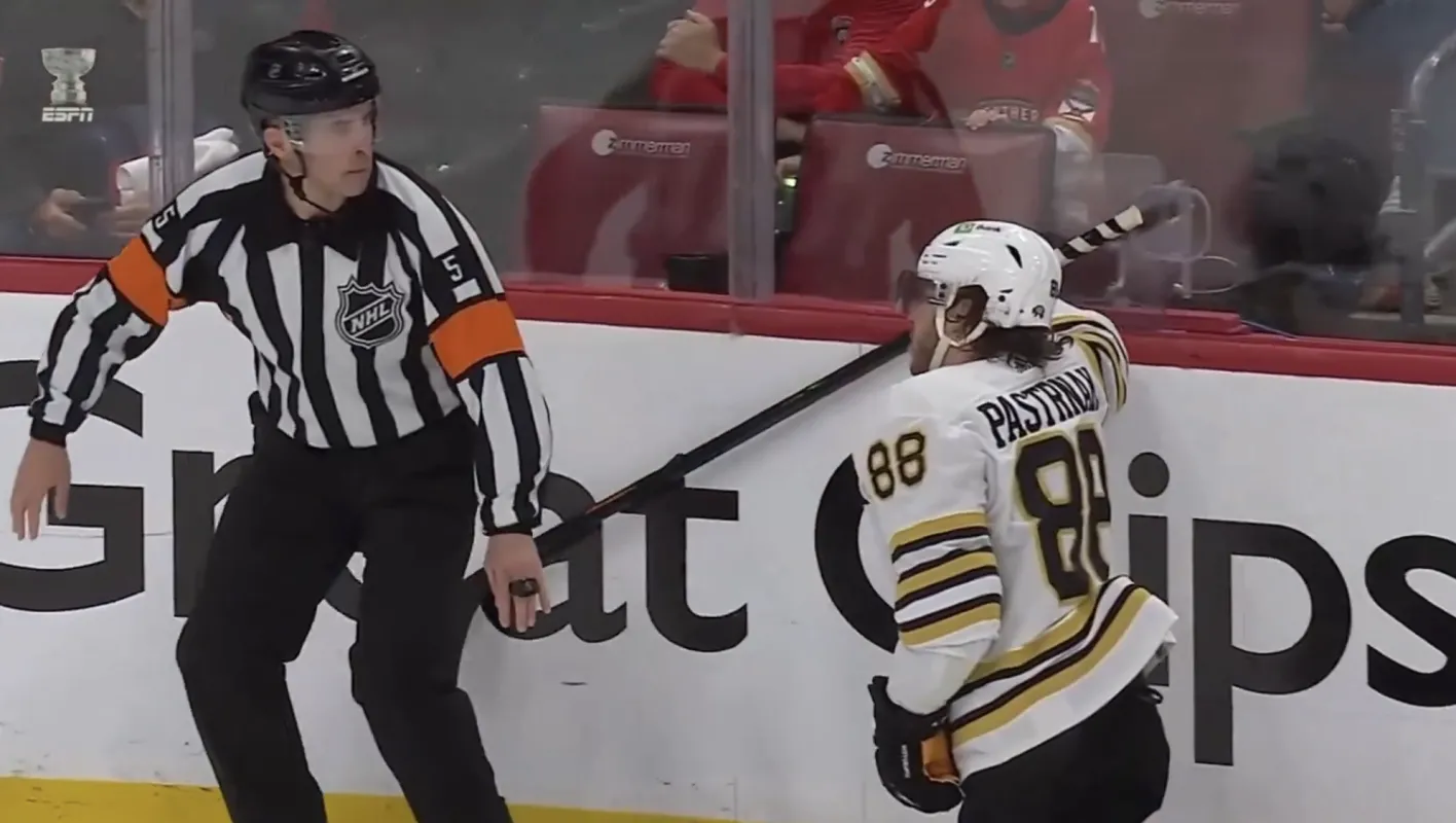 Boston Bruins' David Pastrnak colliding with referee Chris Rooney