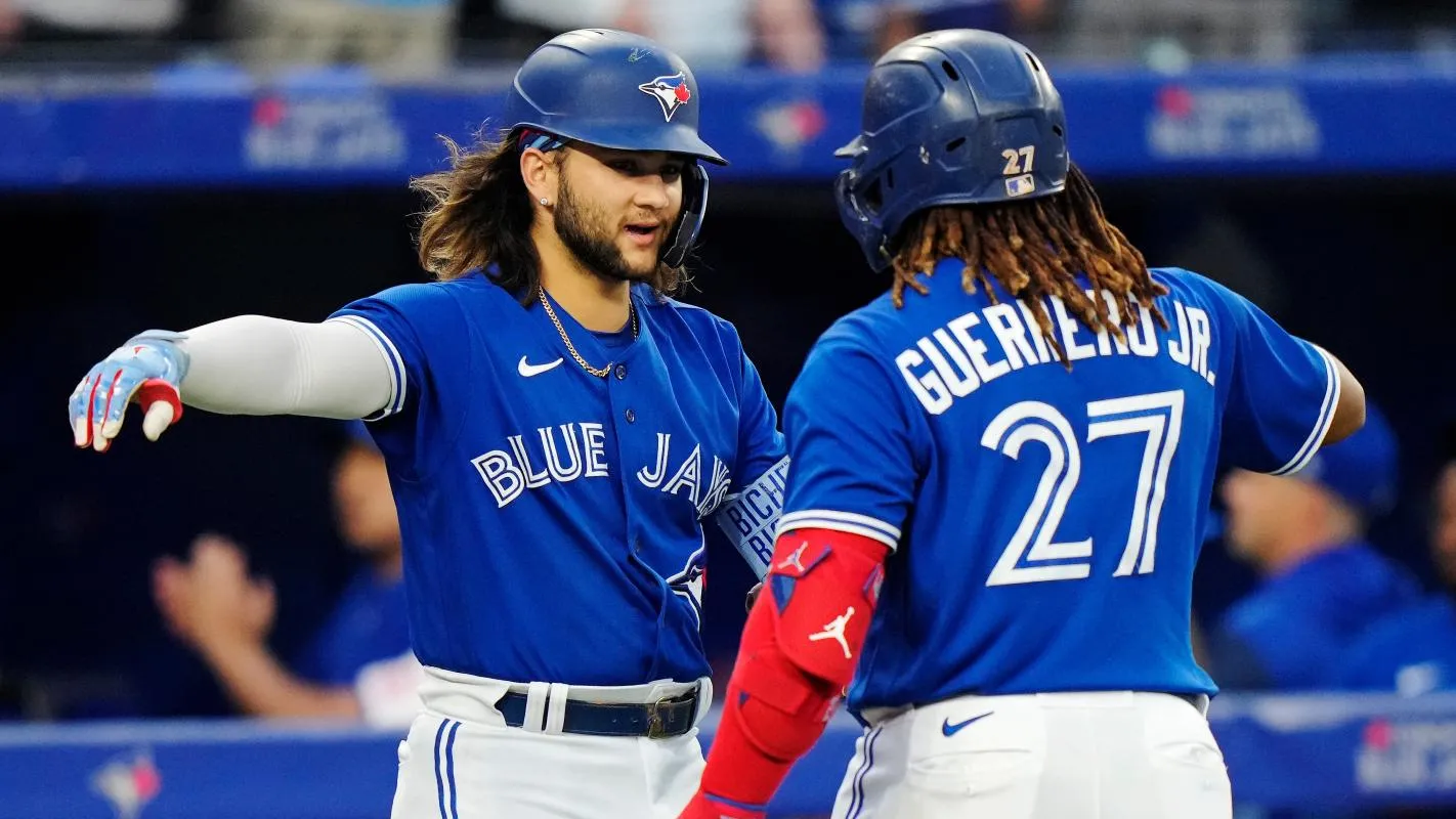 Vlad Guerrero Jr. and Bo Bichette celebrating a run scored..