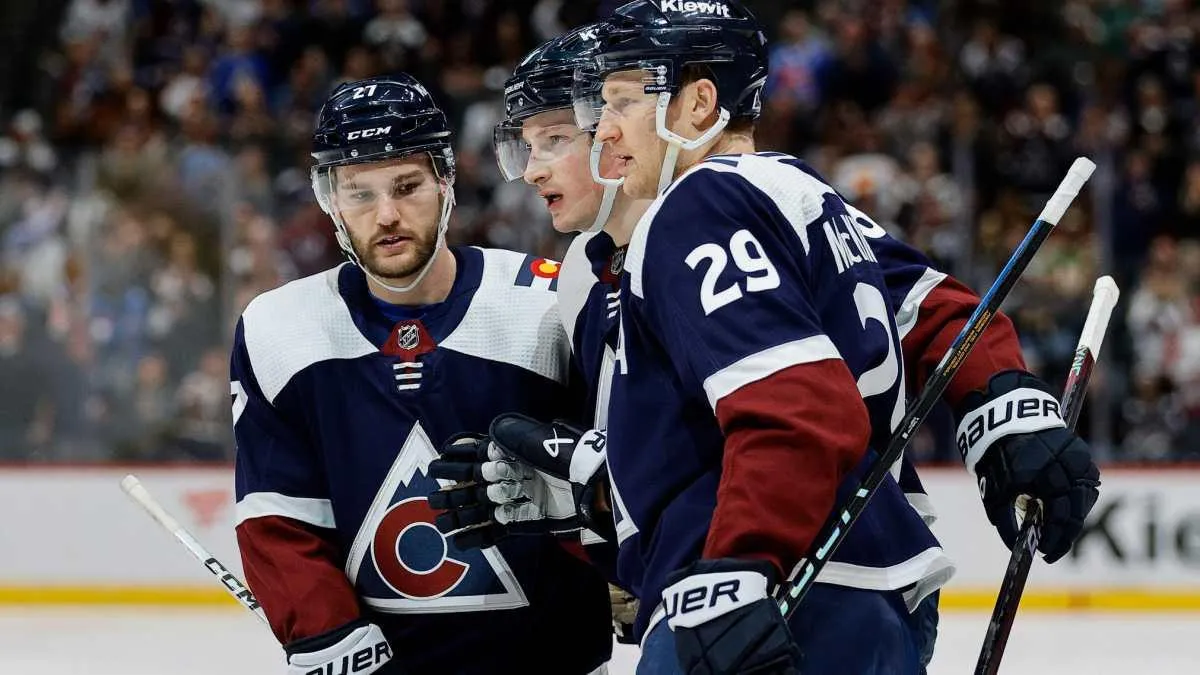 Colorado Avalanche players Cale Makar, Nathan MacKinnon and Jonathan Drouin on the ice during a game.