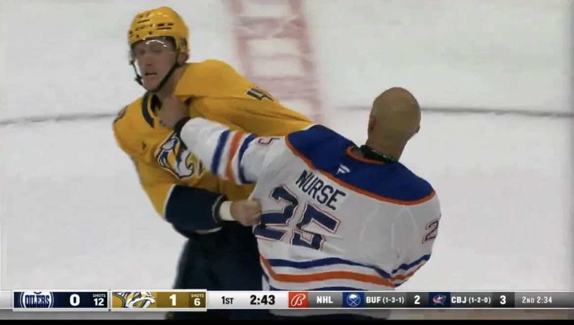 Edmonton Oilers defenseman Darnell Nurse dropping the gloves against Nashville Predators forward Michael McCarron.