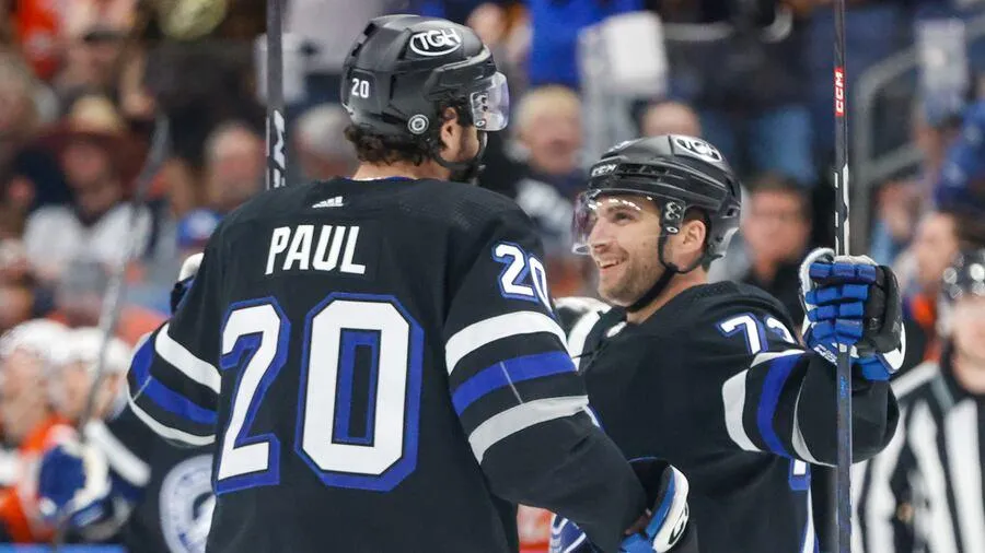 Tampa Bay Lightning forwards Nick Paul and Conor Sheary celebrating a goal.