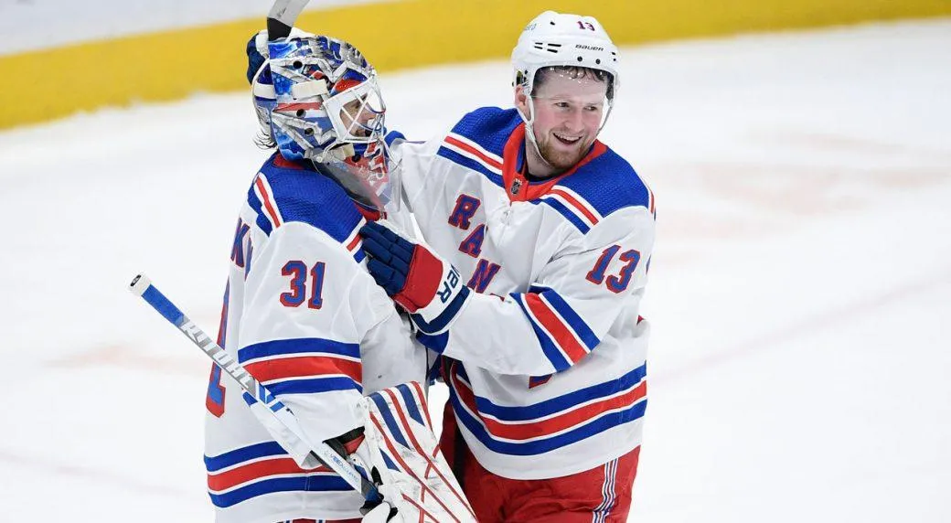 Alexis Lafreniere and Igor Shesterkin share a hug after a New York rangers victory