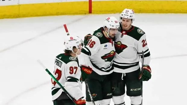 Pavel Novak seen celebrating a goal with his Minnesota Wild teammates