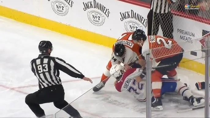 Arber Xhekaj taken down by two Philadelphia Flyers players.