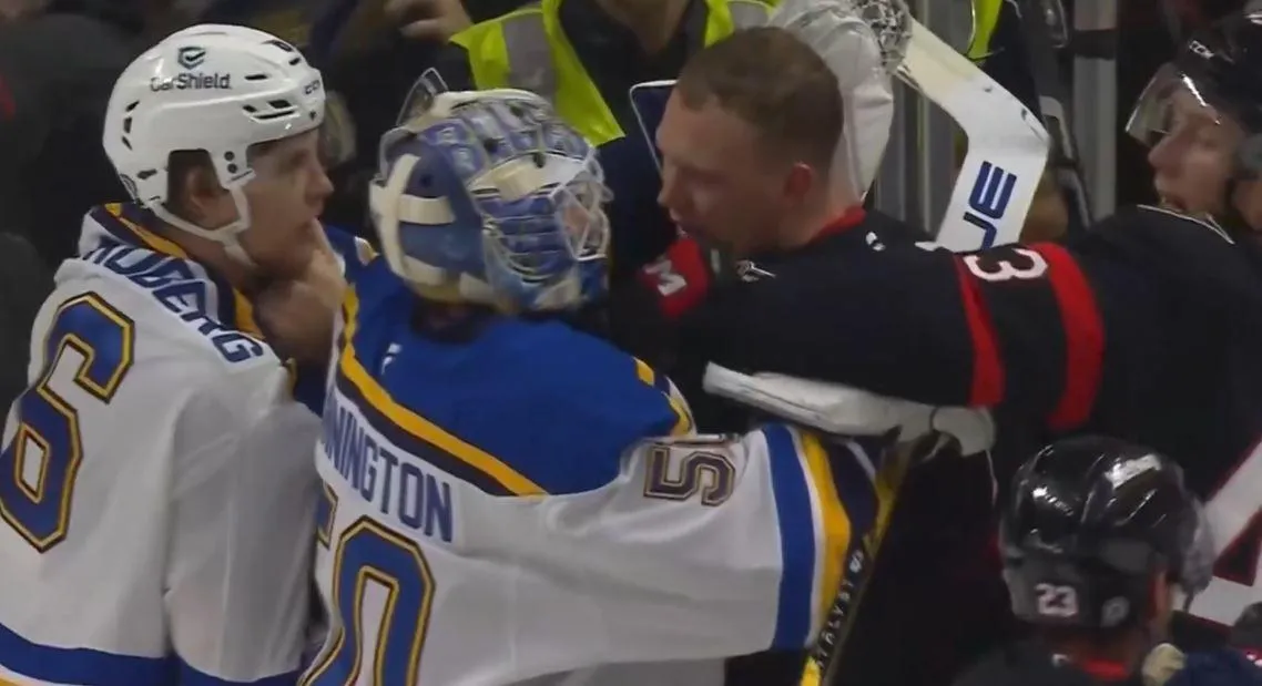 St. Louis Blues goaltender Jordan Binnington in a scrum with Ottawa Senators captain Brady Tkachuk.