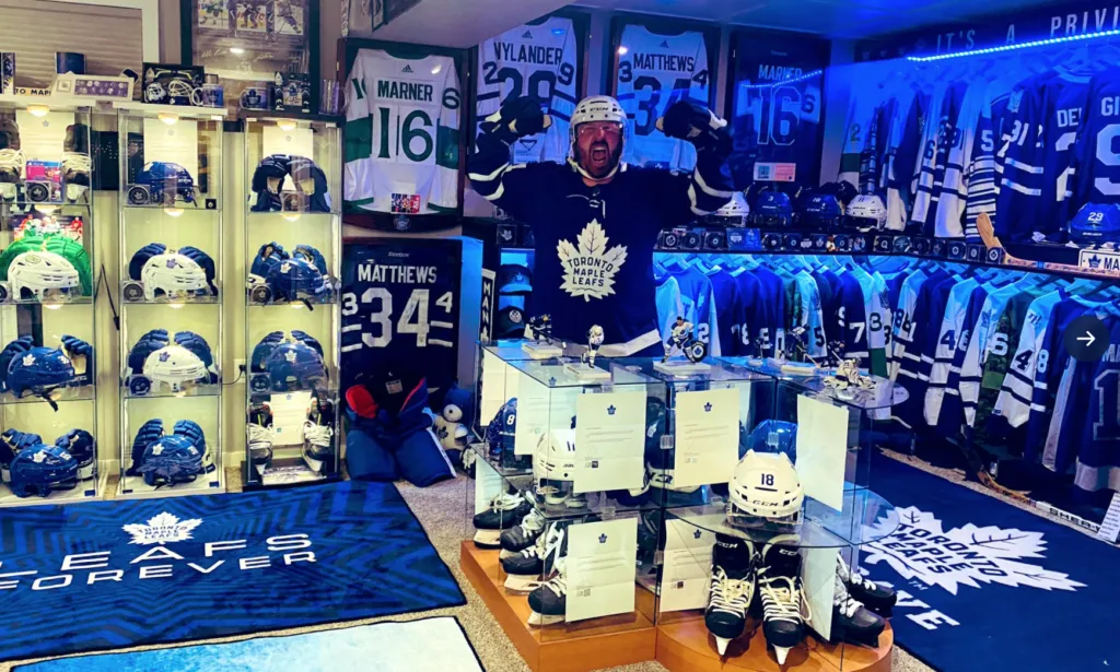 Kurtis from Alberta seen in his house with Maple Leafs memorabilia