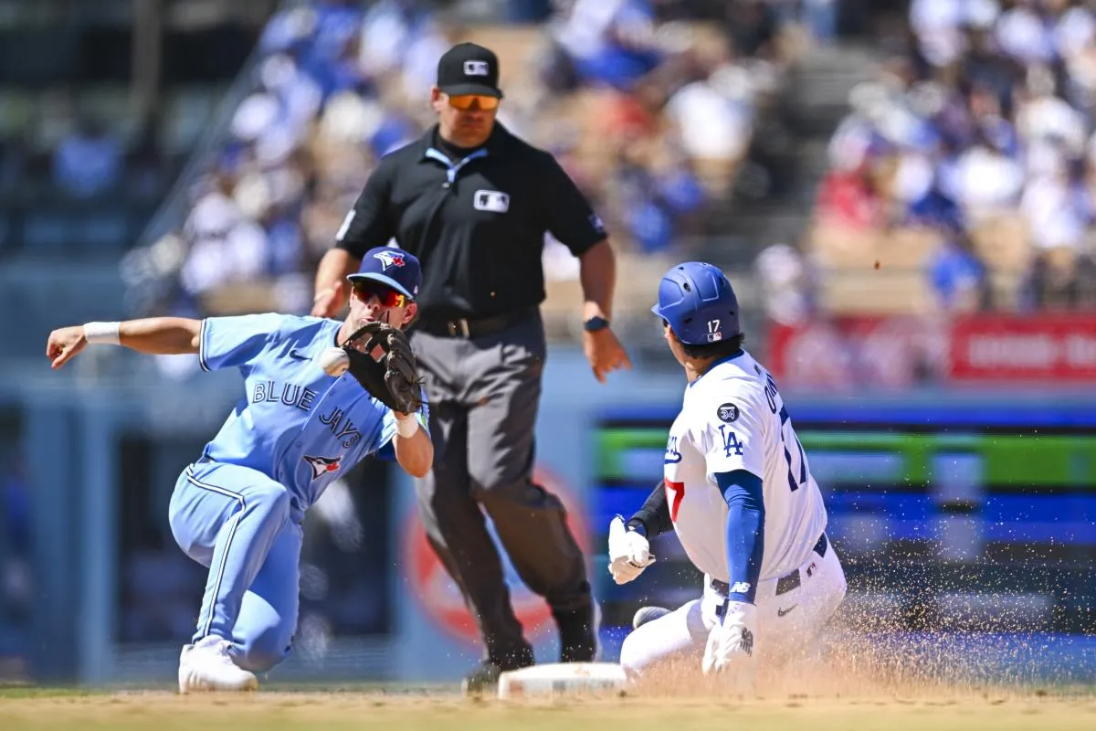Los Angeles Dodgers designated hitter Shohei Ohtani (17) steals second base against Toronto Blue Jays second baseman Ernie Clement (22) during the sixth inning at Dodger Stadium.