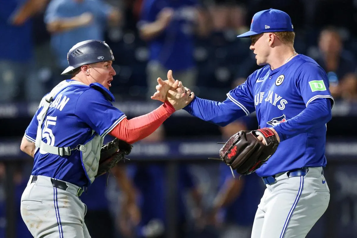 Toronto Blue Jays catcher Tyler Heineman (55) and pitcher Braydon Fisher (63) celebrate after beating the Tampa Bay Rays in extra inning at George M. Steinbrenner Field