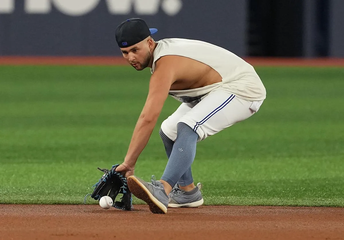 Toronto Blue Jays shortstop Bo Bichette (11) fields balls during batting practice before a game against the Texas Rangers at Rogers Centre.