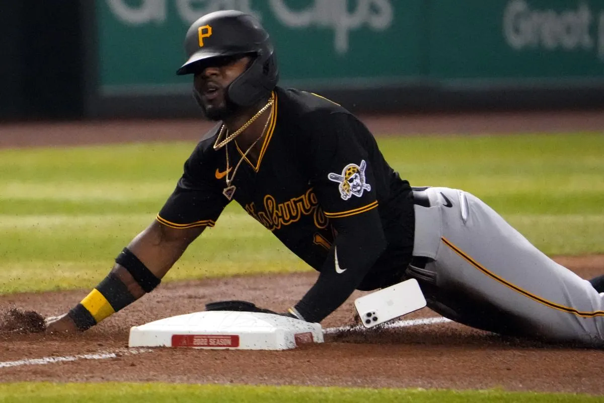 Pittsburgh Pirates second baseman Rodolfo Castro (14) loses his iPhone mobile cell phone as he slides into third base against the Arizona Diamondbacks during the fourth inning at Chase Field.