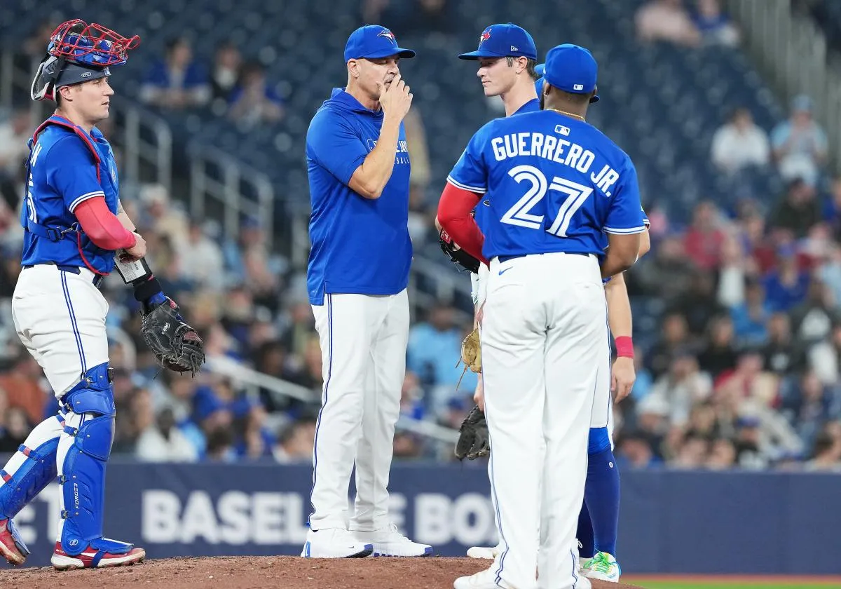 Toronto Blue Jays pitching coach Pete Walker (41) talks with starting pitcher Easton Lucas (62) against the Atlanta Braves during the fifth inning at Rogers Centre.
