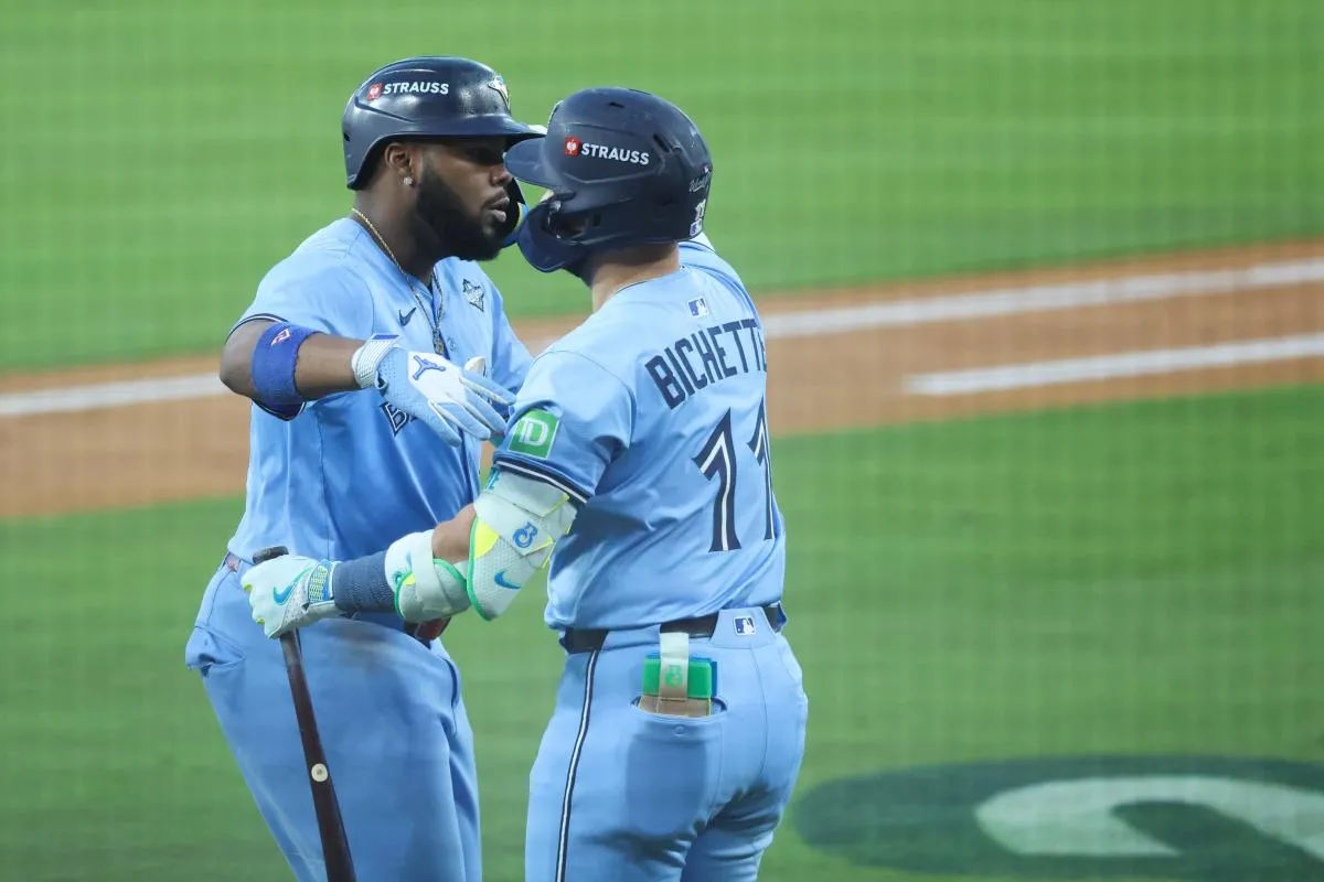 Toronto Blue Jays first baseman Vladimir Guerrero Jr. (27) celebrates with Toronto Blue Jays designated hitter Bo Bichette (11) after hitting a two run home run during the third inning against the Los Angeles Dodgers during game four of the 2025 MLB World Series at Dodger Stadium.