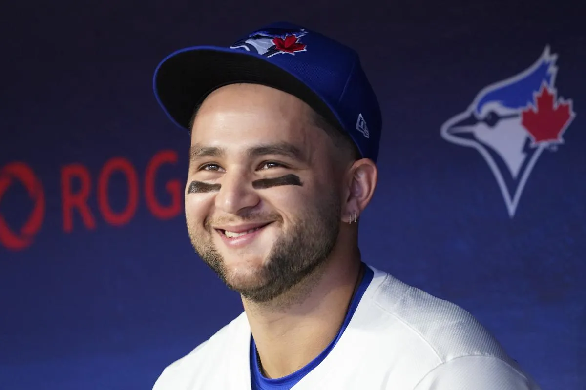Toronto Blue Jays shortstop Bo Bichette (11) smiles in the dugout before the start of the game against the Atlanta Braves at Rogers Centre.