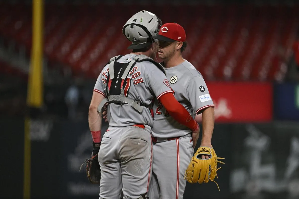 Cincinnati Reds catcher Tyler Stephenson (37) and relief pitcher Emilio Pagan (21) celebrate after beating the St. Louis Cardinals at Busch Stadium.