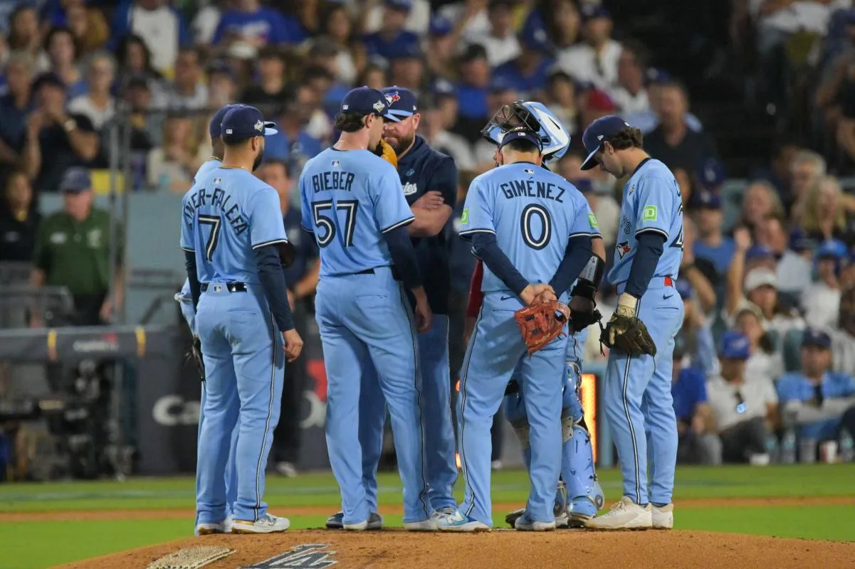 Toronto Blue Jays manager John Schneider (14) pulls Toronto Blue Jays pitcher Shane Bieber (57) from the game during the sixth inning against the Los Angeles Dodgers during game four of the 2025 MLB World Series at Dodger Stadium.