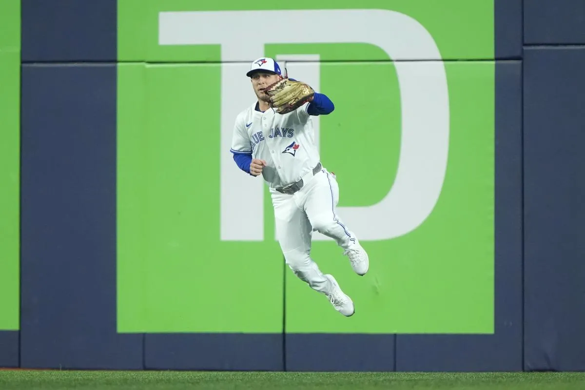 Toronto Blue Jays center fielder Daulton Varsho (5) fields a ground ball hit by Los Angeles Dodgers two-way player Shohei Ohtani (17) in the first inning during game seven of the 2025 MLB World Series at Rogers Centre.