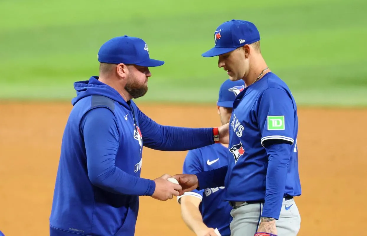 Toronto Blue Jays manager John Schneider (14) removes Toronto Blue Jays starting pitcher Bowden Francis (44) during the sixth inning against the Texas Rangers at Globe Life Field.