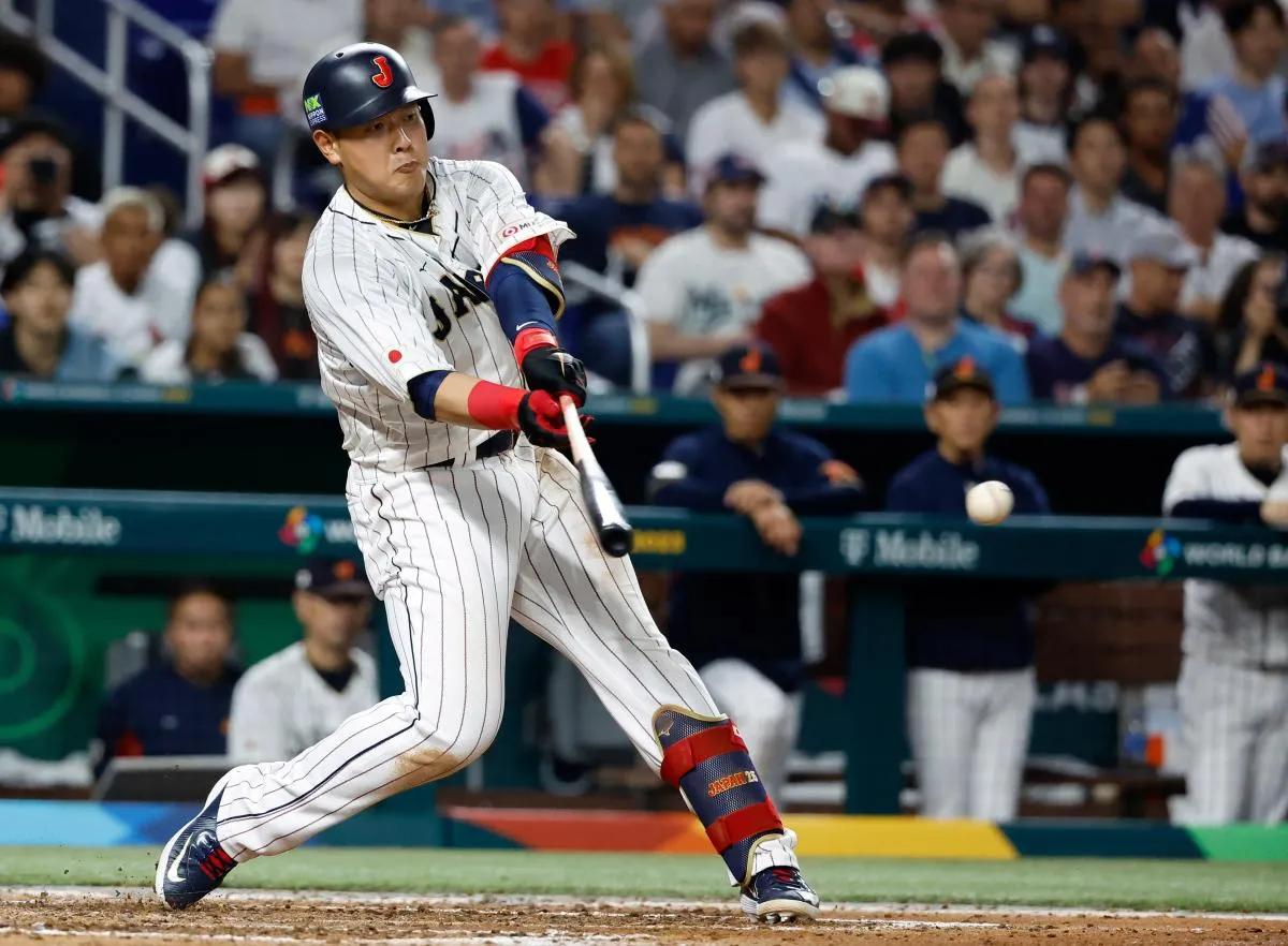 Japan first baseman Kazuma Okamoto (25) bats against the USA in the sixth inning at LoanDepot Park.