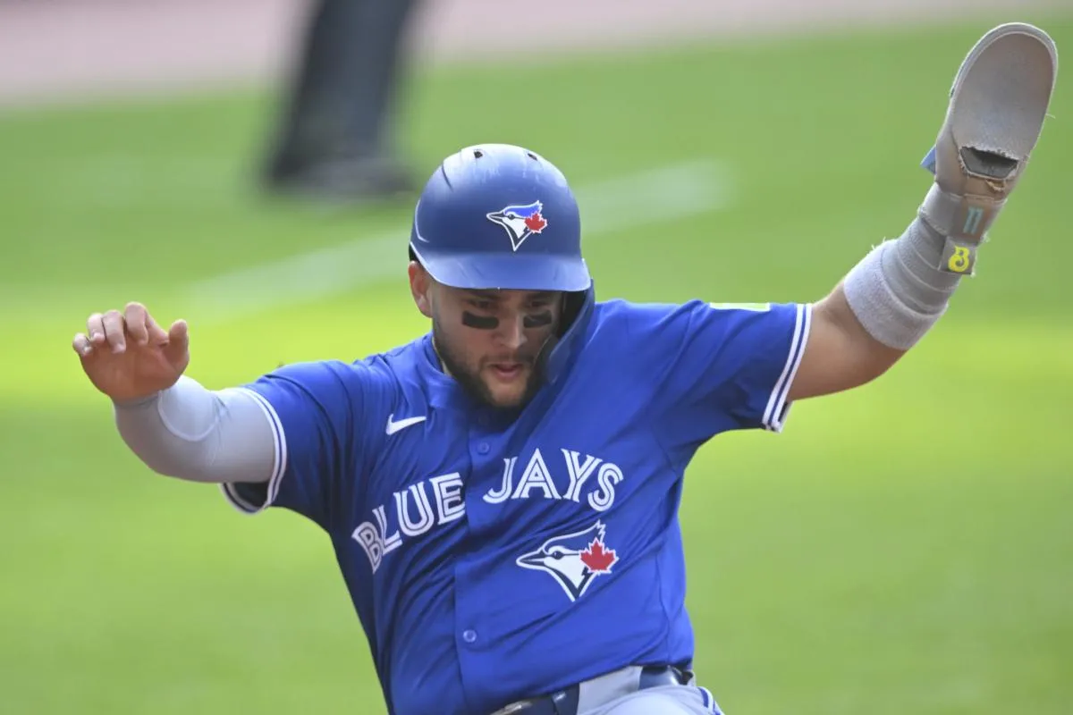 Toronto Blue Jays shortstop Bo Bichette (11) scores in the first inning against the Cleveland Guardians at Progressive Field.