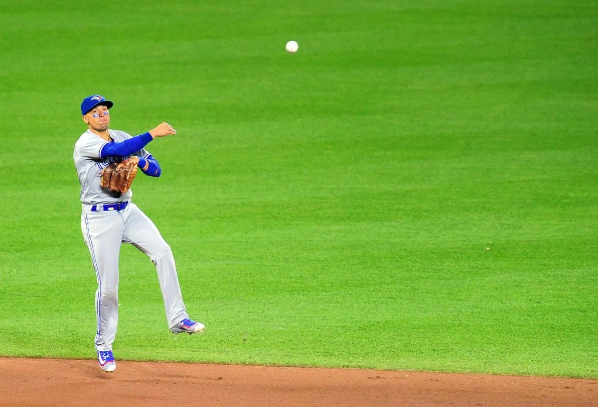 Toronto Blue Jays shortstop Ryan Goins (17) throws the ball to first base in the fifth inning against the Baltimore Orioles at Oriole Park at Camden Yards.
