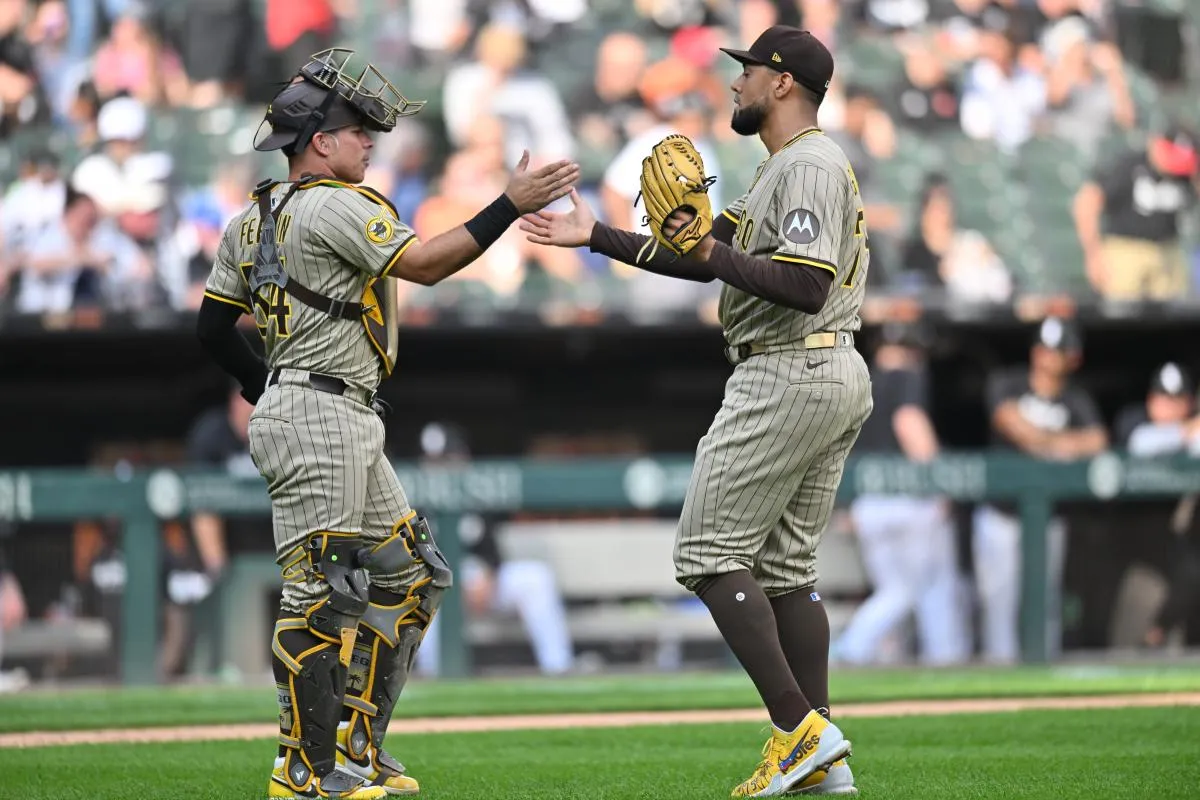 San Diego Padres pitcher Robert Suarez (75) celebrates with catcher Freddy Fermin (54) after defeating the Chicago White Sox during the ninth inning at Rate Field.