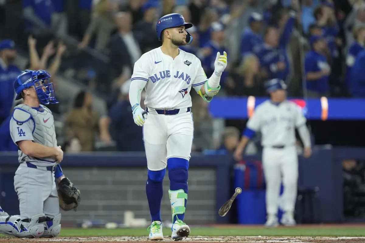 Toronto Blue Jays designated hitter Bo Bichette (11) reacts after hitting a three run home run against the Los Angeles Dodgers in the third inning during game seven of the 2025 MLB World Series at Rogers Centre.