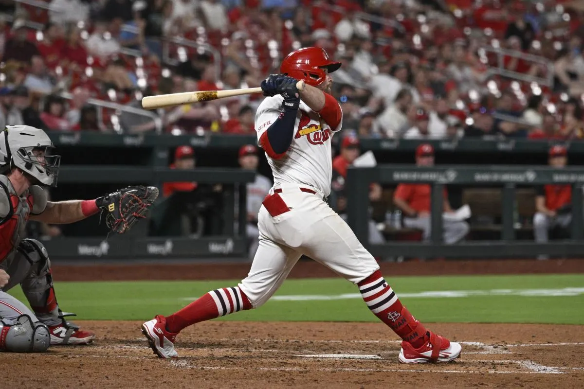 St. Louis Cardinals second baseman Brendan Donovan (21) hits a single against the Cincinnati Reds in the sixth inning at Busch Stadium.