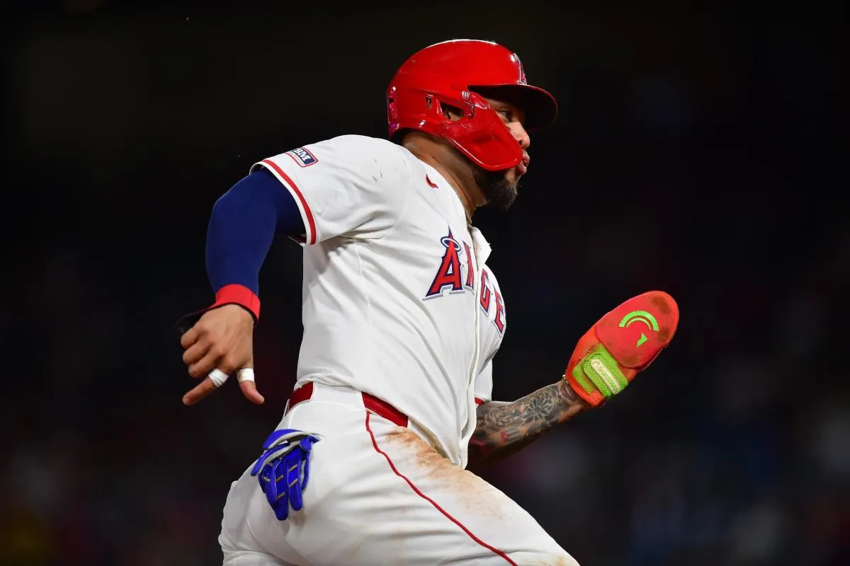 Los Angeles Angels third baseman Yoán Moncada (5) runs home to score against the Minnesota Twins during the fifth inning at Angel Stadium.