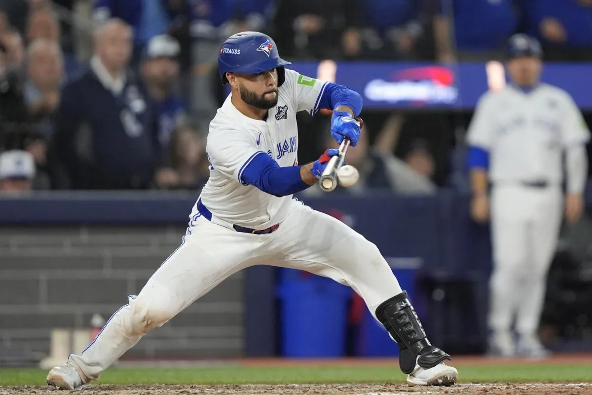 Toronto Blue Jays second baseman Isiah Kiner-Falefa (7) bunts against the Los Angeles Dodgers in the eleventh inning during game seven of the 2025 MLB World Series at Rogers Centre.