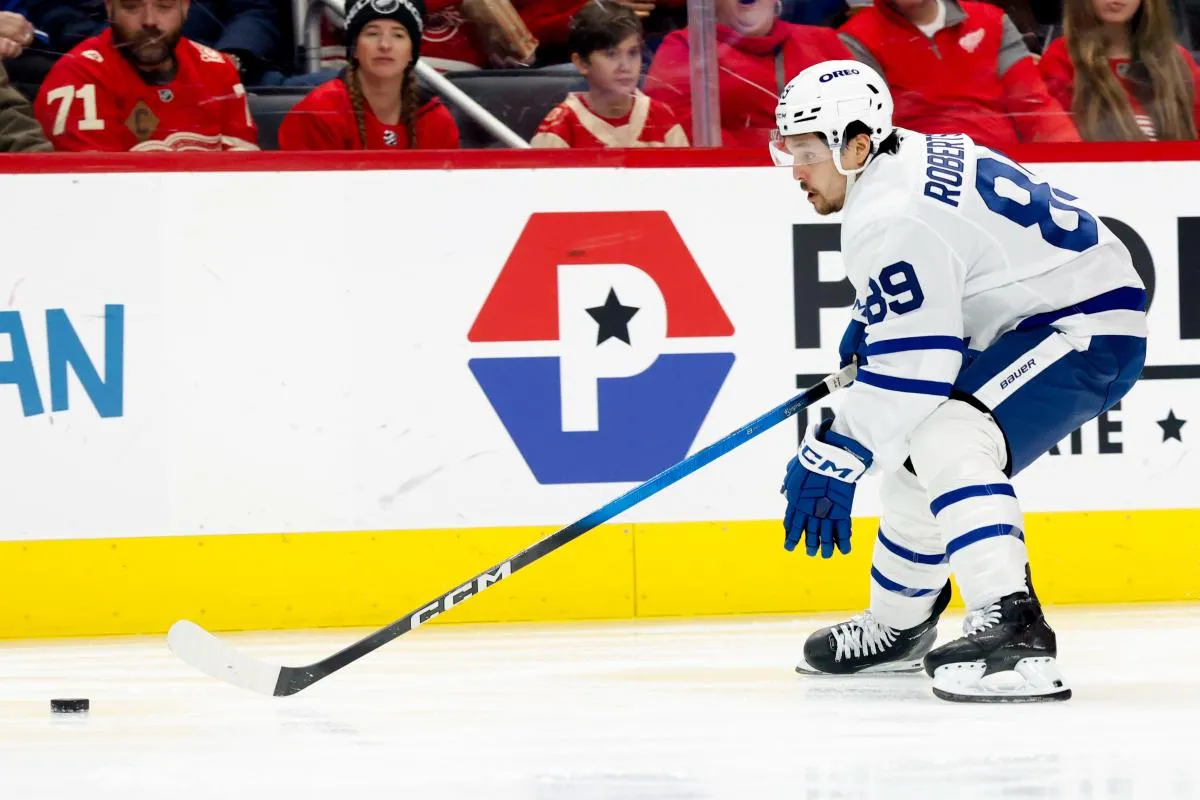 Toronto Maple Leafs left wing Nicholas Robertson (89) skates with the puck defended by Detroit Red Wings left wing J.T. Compher (37) in the first period at Little Caesars Arena.