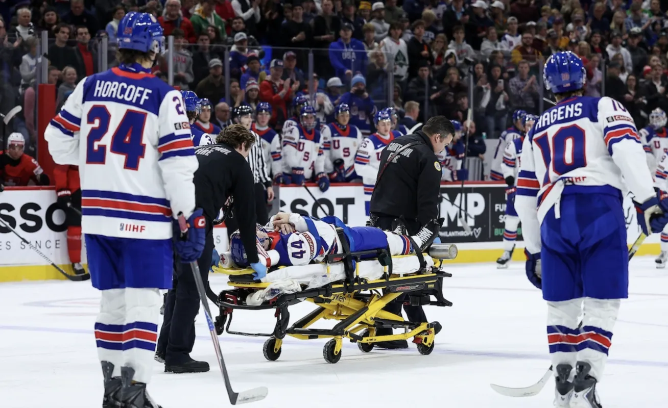 Cole Hutson stretchered off