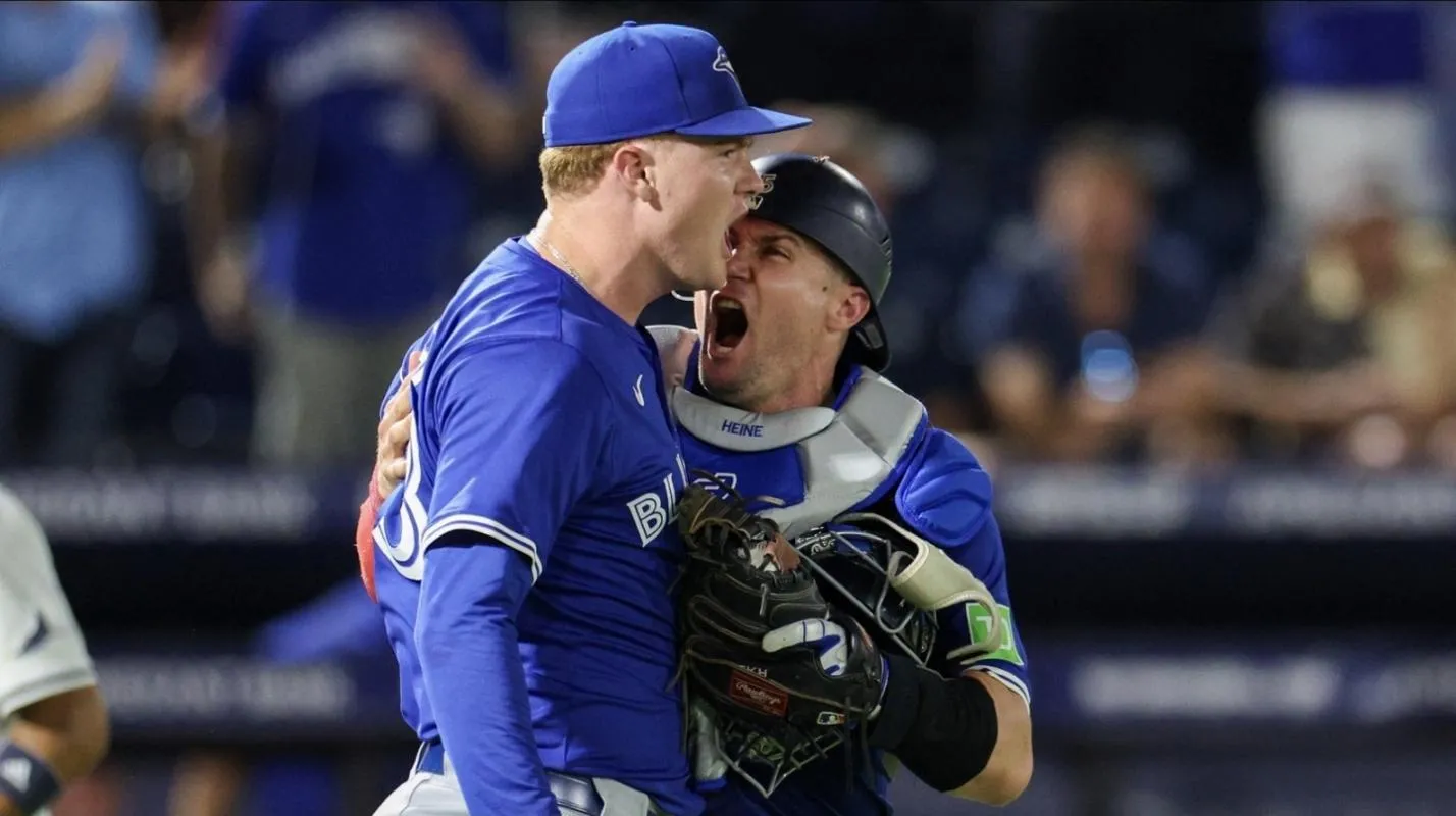 Toronto Blue Jays catcher Tyler Heineman (55) and pitcher Braydon Fisher (63) celebrate after beating the Tampa Bay Rays in extra inning at George M. Steinbrenner Field.