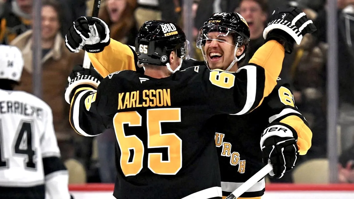 Pittsburgh Penguins' Erik Karlsson and Rickard Rakell celebrate a goal