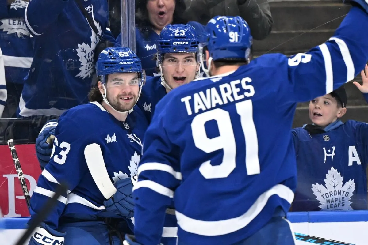 Toronto Maple Leafs forward Matias Maccelli (63) celebrates with forwards Matthew Knies (23) and John Tavares (91) after scoring a goal against the Winnipeg Jets in the third period at Scotiabank Arena.