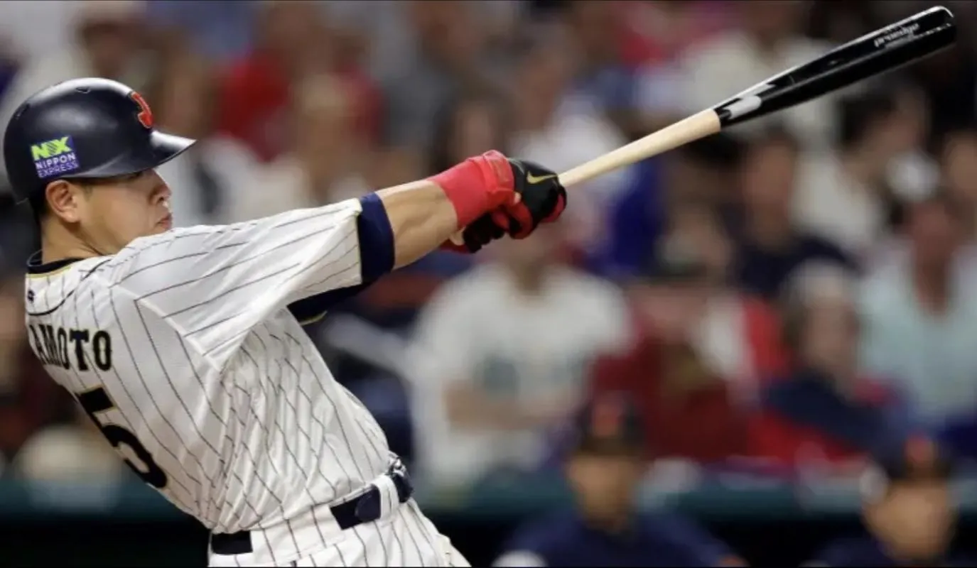 Yomiuri Giants first baseman Kazuma Okamoto (25) hits a home run for Team Japan.