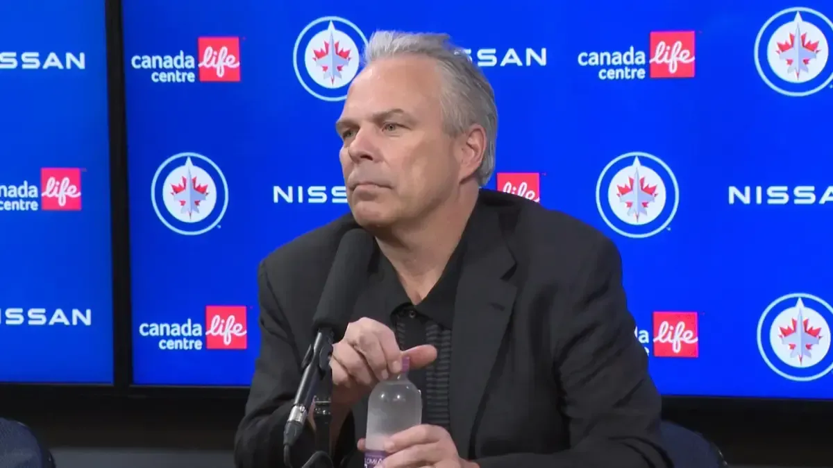 Winnipeg Jets GM Kevin Cheveldayoff sits at a press conference