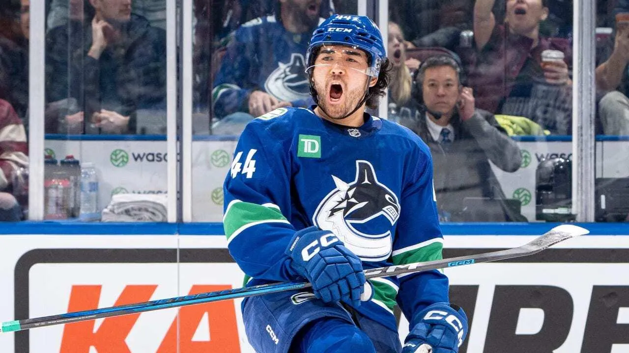 Vancouver Canucks forward Kiefer Sherwood celebrating a goal during a home game.