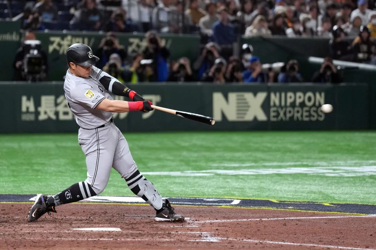 Yomiuri Giants first baseman Kazuma Okamoto (25) hits an RBI double against the Chicago Cubs during the fifth inning at Tokyo Dome.