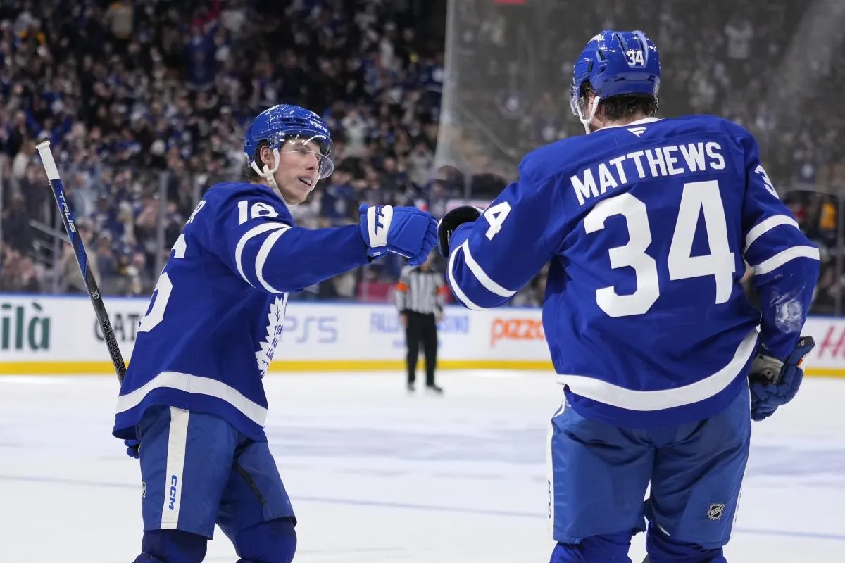 Toronto Maple Leafs forward Mitch Marner (16) congratulate Toronto Maple Leafs forward Auston Matthews (34) after his goal against the Boston Bruins during the third period at Scotiabank Arena.
