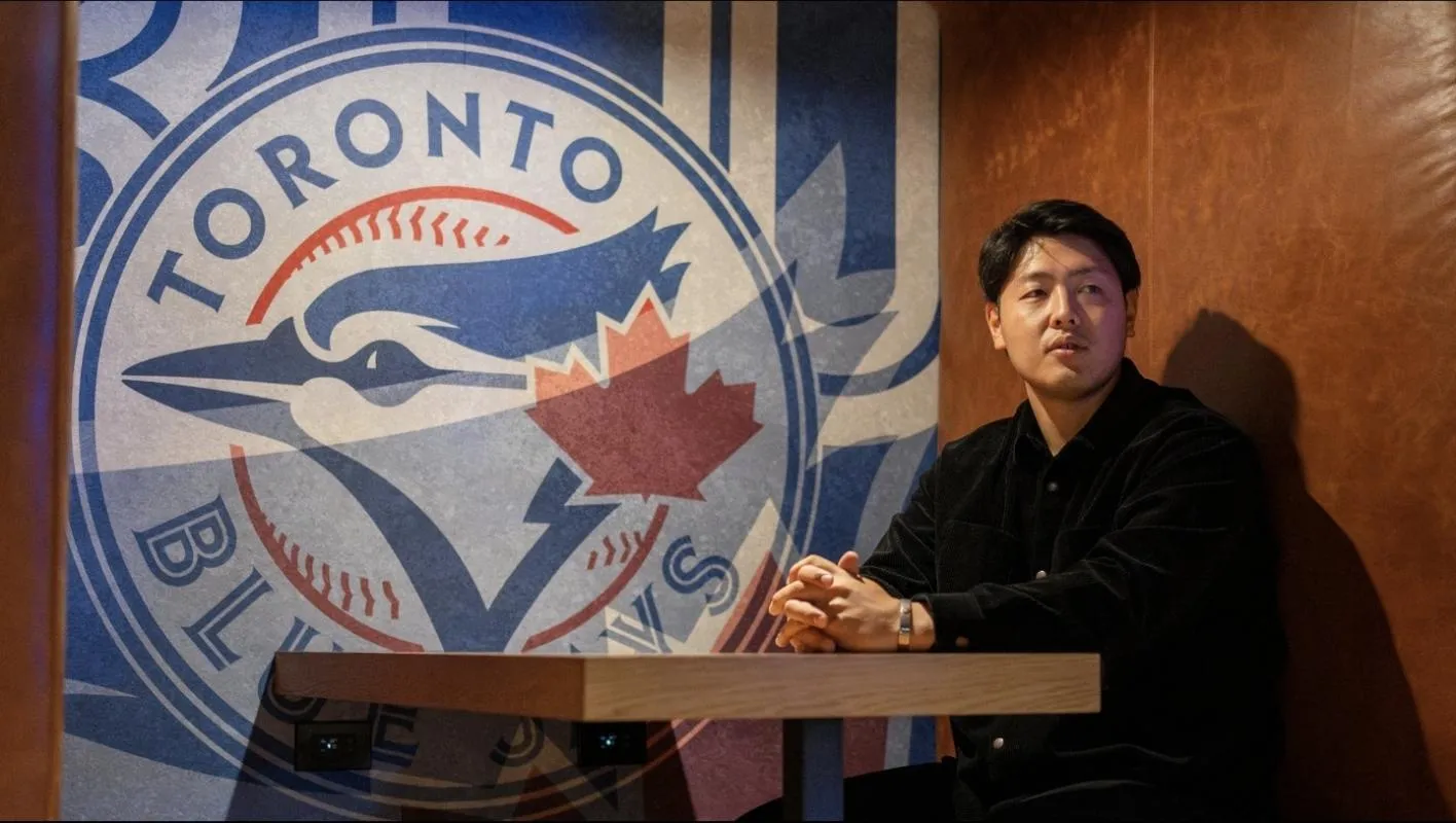 Monday January 5, 2026: New Toronto Blue Jays infielder Kazuma Okamoto poses with the teams logo at Rogers Centre.